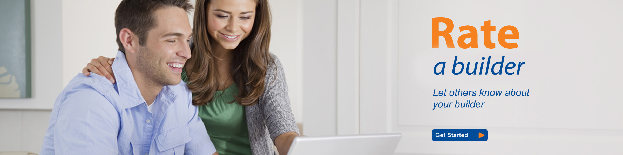 A happy couple at a computer adding a builder review